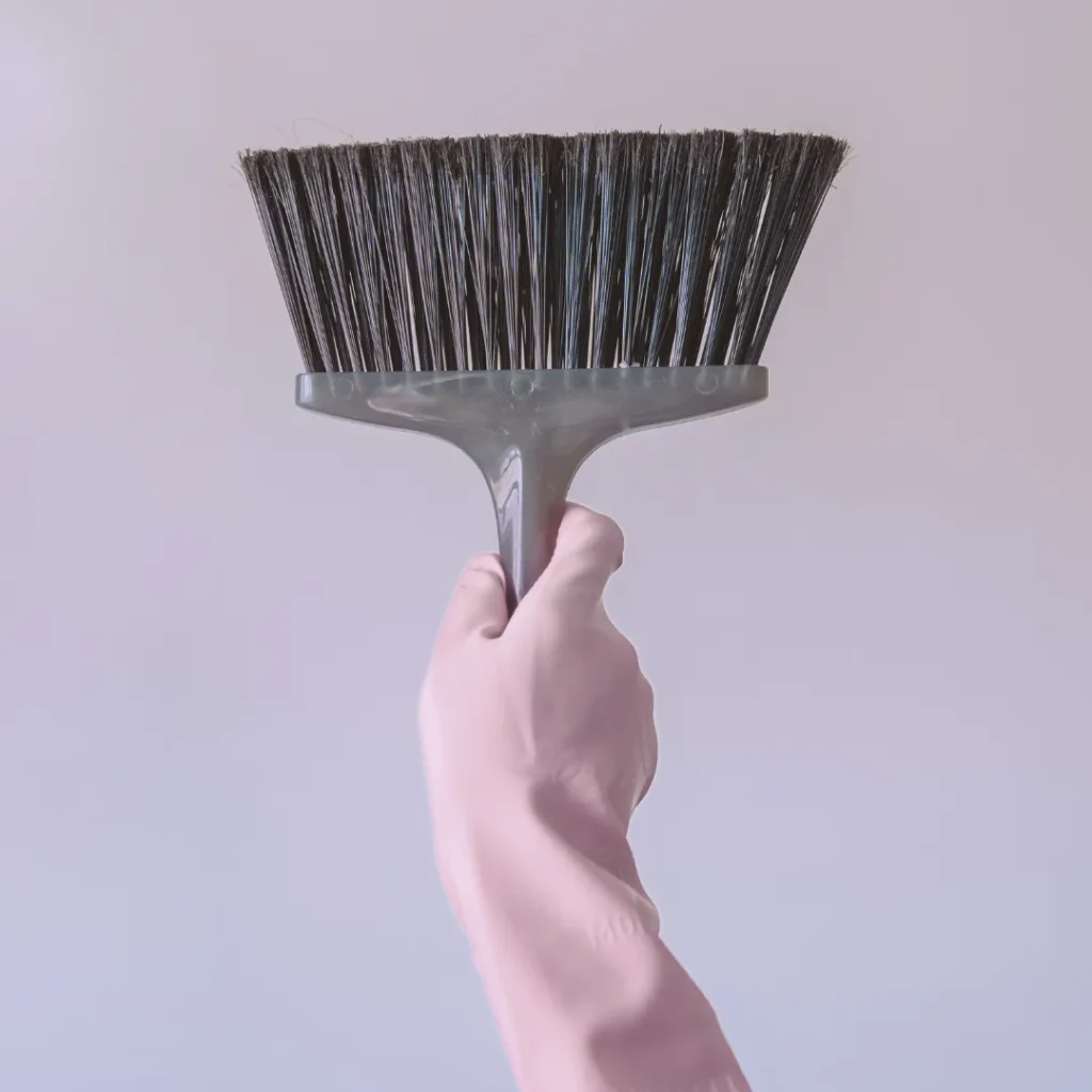 Woman cleaning living room during regular house cleaning in Monmouth County NJ
